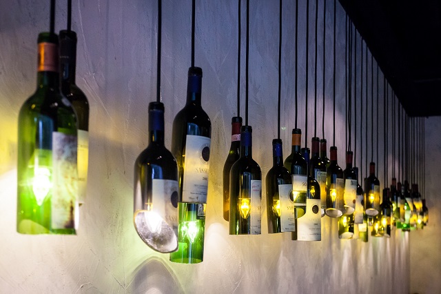 DECOR BY BOTTLE: A staffer told us that this light fixture on the left wall of the store was done by hand with specific bottles, most of them coming from Italian breweries. Bottle neck size was a key consideration in order to fit the light bulbs into the bottle without it dropping. He said the store may change bottles to display in the future.